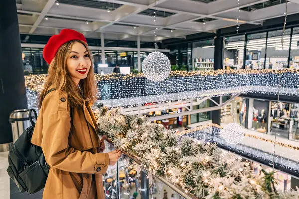 stylish woman embraces the holiday spirit while shopping at the Christmas mall, her portrait capturing the festive atmosphere and joyful anticipation of the season.