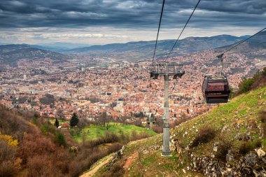Saraybosna 'nın ikonik teleferiğinde manzaralı bir gezinti, aşağıdaki şehir manzarasının panoramik manzarasını sunuyor.