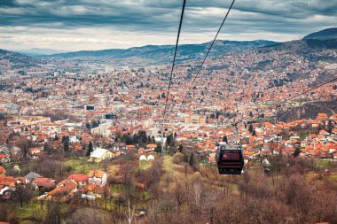 Saraybosna 'nın ikonik teleferiğinde manzaralı bir gezinti, aşağıdaki şehir manzarasının panoramik manzarasını sunuyor.