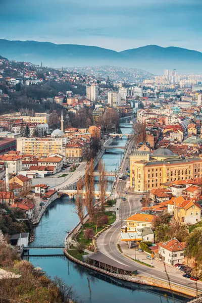Sarajevo\'s enchanting cityscape, nestled amidst rolling hills, captures the essence of Bosnia\'s historic capital.