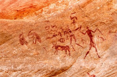 Prehistoric Petroglyphs. Rock Art.  Famous prehistoric rock paintings.  Tadrart Rouge. Tassili N'Ajjer National Park. Sahara Algerian Desert. Illizi Province, Djanet, Algeria, Africa  