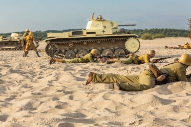 Bdw desert, Silesia, Poland  July, 13, 2024 : Reconstruction of battle from the Second World War. Tobruk 1942. German Afrika Korps soldiers during battle. clipart