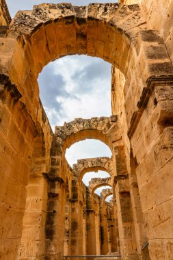 Interior of the Roman amphitheater at the former Thysdrus. A fragment of the arched corridor. El Jem, Mahdia, Tunisia, Africa clipart