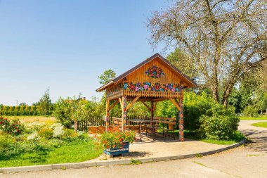 Zalipie, Poland. September 9, 2023: Polish culture and folk art. Wooden wiata painted with colorful fancy flowers clipart