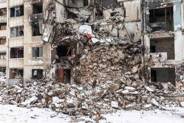 KHARKIV, UKRAINE - Mar. 02, 2023: The scars of war in Ukraine. Destroyed apartment building. Aftermath of a rocket attack, capturing the devastating impact of war in North Saltivka, Kharkiv.