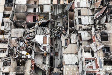 KHARKIV, UKRAINE - Mar. 02, 2023: The scars of war in Ukraine. Destroyed apartment building. Aftermath of a rocket attack, capturing the devastating impact of war in North Saltivka, Kharkiv.