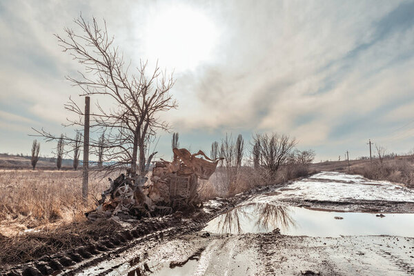 DONETSK REG., UKRAINE - Feb. 14, 2024: Destroyed Russian military equipment is seen along a road in Donetsk region