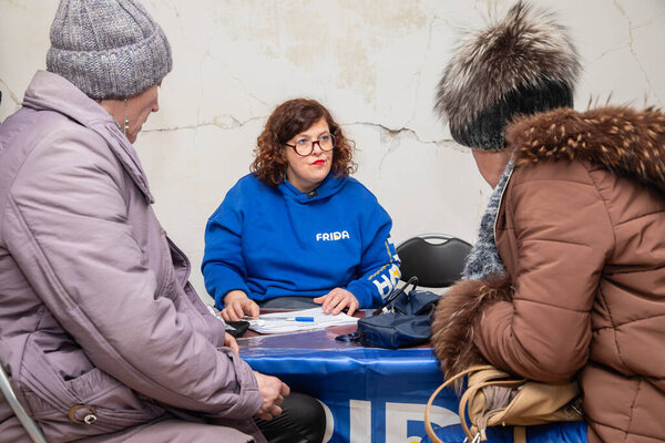 CHASIV YAR, DONETSK REG., UKRAINE - Mar. 09, 2024: Local residents are consulting on health issues with volunteer doctors from the Frida Ukraine Mission 