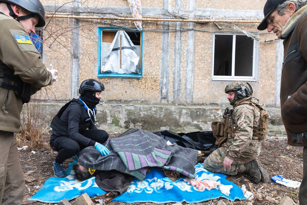 CHASIV YAR, DONETSK REG., UKRAINE - Mar. 09, 2024: Volunteer medics and a military officer are seen unsuccessfully trying to save a wounded man wounded by Russian shelling.