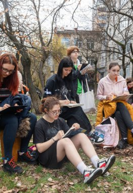 KYIV, UKRAINE - Mar. 30, 2024: Sanat akademisi öğrencileri yıkılan akademi binasının yıkıntılarının kaldırılması sırasında sanatsal eskizler çiziyorlar.