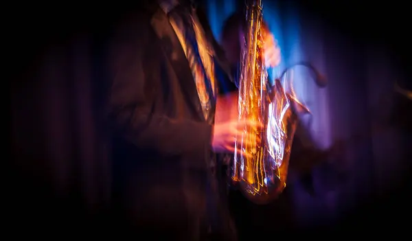 Stock image Abstract motion blurred image of a jazz saxaphonist improvising on stage. Jazz music concept.