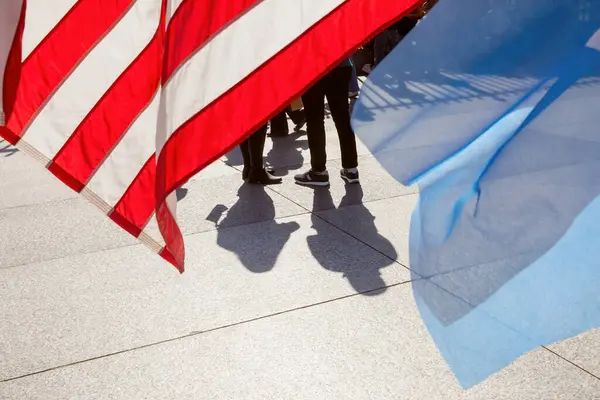 stock image Washington DC, USA - Oct. 10, 2022: Silhouettes of people united under the American flag. Patriotic demonstration near the White House fence