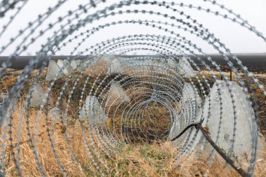 Dragon's teeth fortifications and barbed wire in Kharkiv region, Ukraine, during the Russian-Ukrainian war clipart