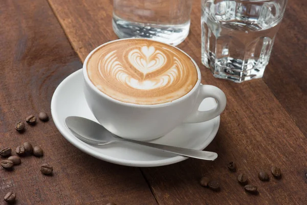 stock image latte coffee art with wood background