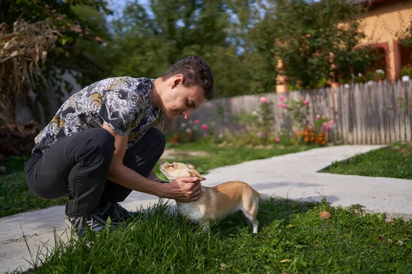 Ung Man Leker Med Sin Hund Utomhus Gräset — Stockfoto