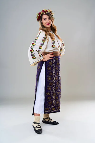 人気のヴィンテージ伝統的なルーマニアの衣装で若い女性 灰色の背景に隔離されました — ストック写真