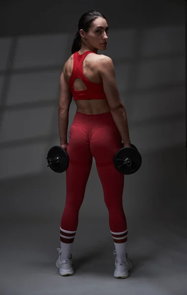 Female Fitness Model Posing Holding Dumbbells Gray Background Window Shadow — Stock Photo, Image