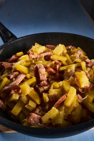 Potatoes and ham in a wok, freshly cooked