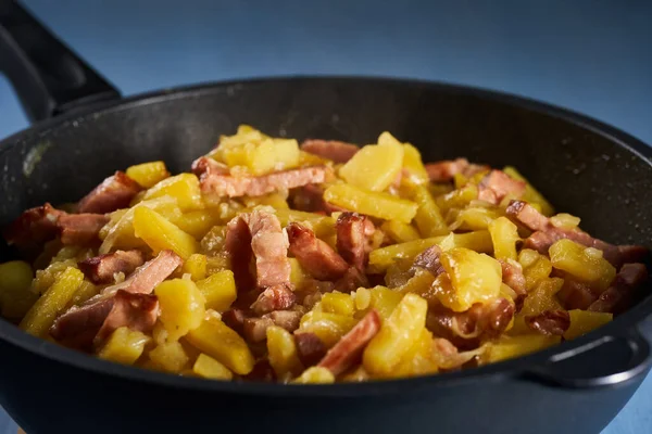 Potatoes and ham in a wok, freshly cooked
