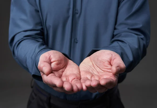 Businessman with both hands outstretched as if holding something, offering or requesting