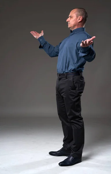 Full body portrait of a businessman with a voila gesture, arms stretched