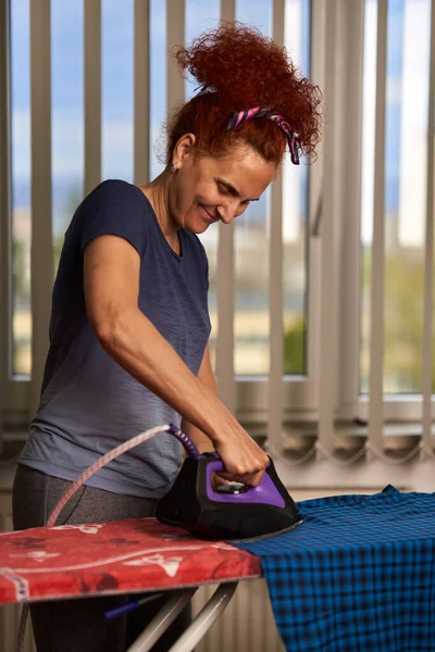 Curly Hair Redhead Housewife Ironing Clothes Window — Stock Photo, Image