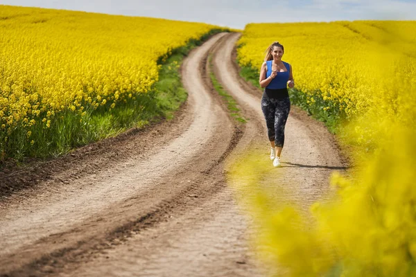 Size Beautiful Latin Woman Jogging Dirt Road Canola Field — Stock Photo, Image