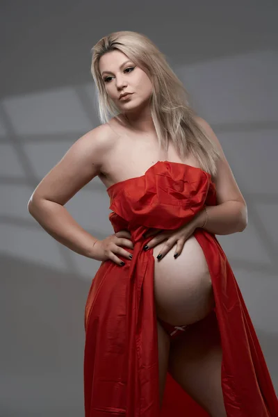 Beautiful Pregnant Young Blonde Woman Red Wavy Sheet Gray Background — Stock Photo, Image