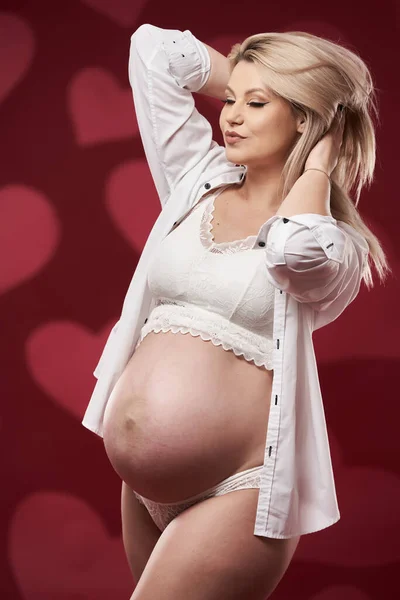 Krásná Těhotná Mladá Blondýna Žena Bílém Spodní Prádlo Červeném Pozadí — Stock fotografie