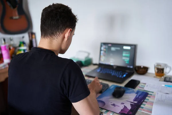 彼のラップトップ上の自宅から働いている若い男のソフトウェア開発者 — ストック写真