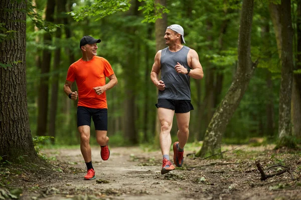 Two Male Friends Running Together Trail Forest — Stock Photo, Image