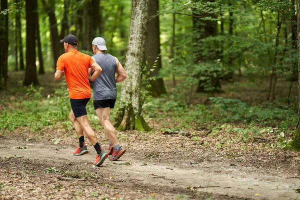 Two Male Friends Running Together Trail Forest — Stock Photo, Image