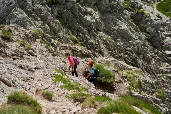 Sırt Çantalı Iki Kadın Kayalık Dağlarda Yürüyüş Yapıyor — Stok fotoğraf