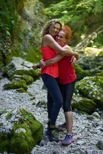 Two women friends enjoying a holiday with canyon exploration and hiking, having fun