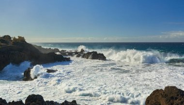 Atlantik okyanusuyla Tenerife kıyısında deniz manzarası, volkanik kıyılara vuran dalgalar.