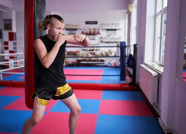 stock image Young kickbox fighter doing warm up in a gym 