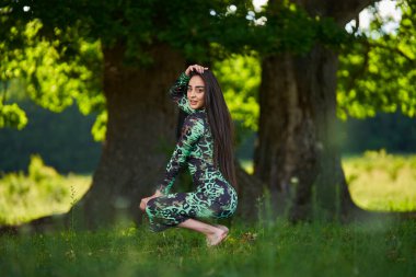 Ormanda yeşil elbiseli İspanyol güzellik modeli  