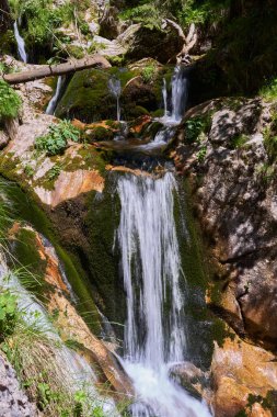 Dağlardaki bir nehirde şelalesi olan yaz manzarası