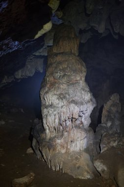 Cave in limestone mountains with various formations clipart