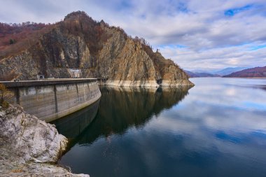 Dağlardaki baraj gölü sonbaharda renkli ormanlarla çevrilidir.