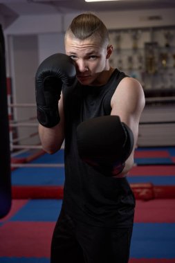 Kickbox kulübünde siyah eldivenli kickboksör portresi.