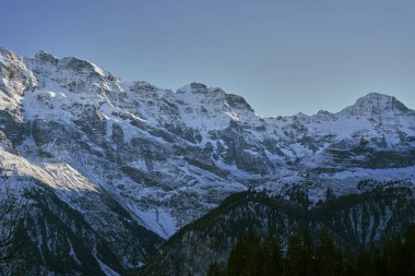 Swiss Alps seen from the picturesque Mirren, a mountain town in Switzerland clipart