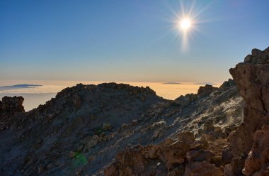 Buharlı jeotermal bacalar Pico del Teide kraterinin içine gaz salıyor. Mineral birikintileri ve dağınık kayalarla, La Palma adası uzaklıktan görülebiliyor.