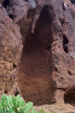 Doğal boşluğu olan volkanik kaya duvarı ve Anaga, Tenerife 'nin kırmızı arazisindeki aşınmış dokuları