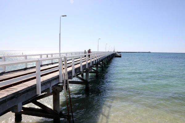 stock image Historical pier in Busselton, Western Australia.  Showing pier, train, buildings, ocean and blue sky