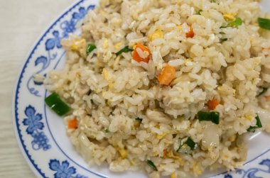 Chinese fried rice in a plate on the table clipart