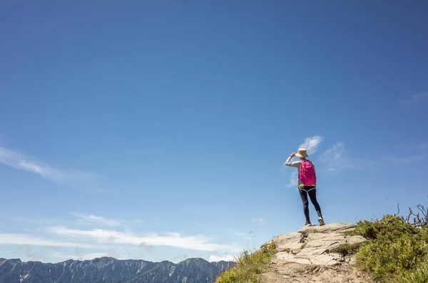 Asian mountain climbing woman pointing at far away in Hehuan mountain, Taiwan