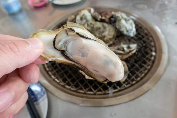 fresh oysters on barbecue grill in a restaurant at Taiwan