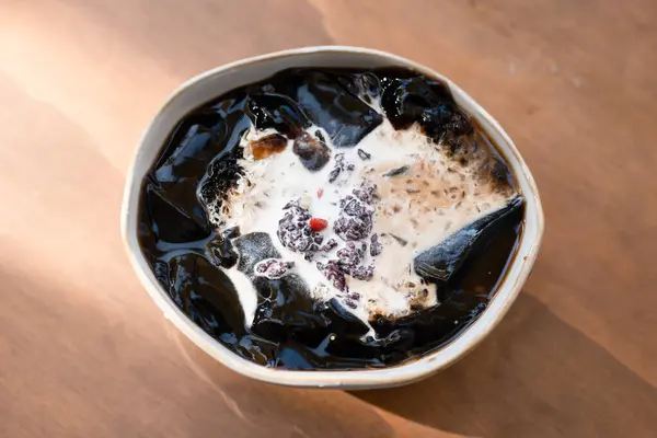 stock image Grass jelly with milk and toppings in a bowl.