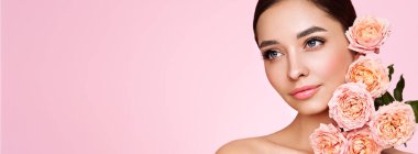 Temiz tenli güzel bir genç kadın portresi. Sağlıklı ciltli bir model, yakın portre. Kozmetik, güzellik ve kaplıca. Gül çiçekli kız.